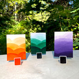 watercolour halfpans with swatches in Papaya, Emerald & Violet.
